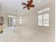 Bright living room with neutral color palette, multiple windows, carpet floors and sliding glass doors at 6324 41St E Ct, Sarasota, FL 34243