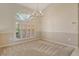 Dining room featuring a chandelier, large window, and neutral carpeting at 6392 Woodbirch Pl, Sarasota, FL 34238