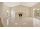 Bright living room with tile flooring, fireplace, and built-in shelving at 6392 Woodbirch Pl, Sarasota, FL 34238