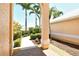 Inviting walkway leading to the home's entrance, framed by lush greenery and palm trees at 6392 Woodbirch Pl, Sarasota, FL 34238