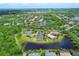 Aerial view of a lakeside community with mature landscaping, water features, and multiple homes at 7710 Seven Oaks Dr, Bradenton, FL 34201