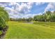 Beautifully maintained backyard with lush green lawn, a pond, and a natural setting at 7710 Seven Oaks Dr, Bradenton, FL 34201