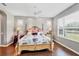 Well-lit bedroom features wood floors, ceiling fan and natural light at 7710 Seven Oaks Dr, Bradenton, FL 34201