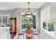 A charming breakfast nook featuring a glass-top table, neutral tones and sliding glass doors at 7710 Seven Oaks Dr, Bradenton, FL 34201