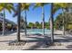 Inviting community pool area featuring lounge chairs and palm trees for a relaxing experience at 7710 Seven Oaks Dr, Bradenton, FL 34201