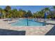 Relaxing zero entry community pool surrounded by palm trees and comfortable lounge chairs for residents at 7710 Seven Oaks Dr, Bradenton, FL 34201