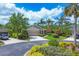 Well-maintained home featuring mature landscaping, circular driveway, and attached two-car garage at 7710 Seven Oaks Dr, Bradenton, FL 34201