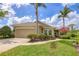 Charming single-story home featuring a two-car garage, lush landscaping, and well-maintained lawn at 7710 Seven Oaks Dr, Bradenton, FL 34201