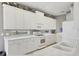 Bright white kitchen featuring modern appliances, ample countertop space, and decorative details at 7710 Seven Oaks Dr, Bradenton, FL 34201