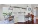 Eat-in kitchen with white cabinets, modern appliances, and a breakfast bar area at 7710 Seven Oaks Dr, Bradenton, FL 34201