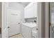 Clean laundry room with modern washer and dryer, ample storage, and organized layout at 7710 Seven Oaks Dr, Bradenton, FL 34201