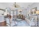 Spacious living room with elegant furnishings, fan and decorative chandelier at 7710 Seven Oaks Dr, Bradenton, FL 34201