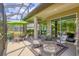 Inviting covered patio with stylish furniture, perfect for outdoor entertaining, with a beautiful backyard view at 7710 Seven Oaks Dr, Bradenton, FL 34201