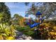 Colorful community playground featuring slides, climbing structures, and a soft, green play surface at 7710 Seven Oaks Dr, Bradenton, FL 34201