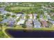Aerial view from the lake with homes and mature trees at 7816 Ashley Cir, University Park, FL 34201