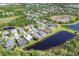 Aerial view of a community with lakes, golf course, and mature landscaping at 7816 Ashley Cir, University Park, FL 34201