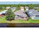 Aerial view from the lake of the home and the screened in porch at 7816 Ashley Cir, University Park, FL 34201