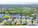 Aerial view of homes with lake views and manicured landscaping at 7816 Ashley Cir, University Park, FL 34201