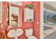 Cozy half-bathroom with a pedestal sink and is located near pool at 7816 Ashley Cir, University Park, FL 34201