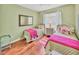 Charming bedroom with two twin beds, hardwood floors and bright decor at 7816 Ashley Cir, University Park, FL 34201
