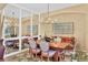 Cozy dining room with a modern chandelier, rug and a large mirror at 7816 Ashley Cir, University Park, FL 34201