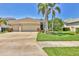 Charming single-story home with a three-car garage, mature landscaping, and a well-manicured lawn at 7816 Ashley Cir, University Park, FL 34201