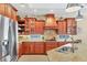 A chef's kitchen with granite counters, custom cabinetry, and stainless steel appliances at 7816 Ashley Cir, University Park, FL 34201