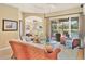 Inviting living room featuring tray ceiling, wicker furniture and lots of natural light at 7816 Ashley Cir, University Park, FL 34201