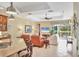 Open concept living room with view to screened outdoor area and granite kitchen counter at 7816 Ashley Cir, University Park, FL 34201