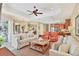 Open-concept living room and kitchen with coffered ceiling, and stainless steel appliances at 7816 Ashley Cir, University Park, FL 34201