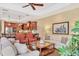 Open-concept living room and kitchen with coffered ceiling, and stainless steel appliances at 7816 Ashley Cir, University Park, FL 34201