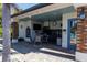 Outdoor kitchen with seating, grill, and television perfect for entertaining by the pool at 7816 Ashley Cir, University Park, FL 34201