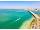 Magnificent aerial view of the bridge and coastline with clear waters and lush palm trees at 800 S Blvd Of The Presidents # 3, Sarasota, FL 34236