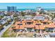 Beautiful aerial view of condo community near beach with turquoise water and city buildings on the horizon at 800 S Blvd Of The Presidents # 3, Sarasota, FL 34236