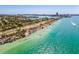 Stunning aerial view of the coastline with clear turquoise water, palm trees, and a picturesque cityscape at 800 S Blvd Of The Presidents # 3, Sarasota, FL 34236