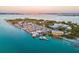 Aerial view showcasing a marina filled with boats alongside the bay, set against a backdrop of city skyline at 800 S Blvd Of The Presidents # 3, Sarasota, FL 34236