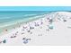 Bustling beachfront with soft white sand, calm turquoise water, and happy beachgoers enjoying a beautiful day at 800 S Blvd Of The Presidents # 3, Sarasota, FL 34236