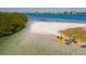 Stunning view of pristine beach featuring golden sand, clear water, kayaks, and lush foliage along the shore at 800 S Blvd Of The Presidents # 3, Sarasota, FL 34236