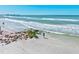 Beautiful beach scene with clear turquoise water, sandy shore, and a person enjoying the tranquility of the ocean at 800 S Blvd Of The Presidents # 3, Sarasota, FL 34236