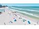 Scenic beach with crystal clear turquoise water, soft white sand, and beachgoers relaxing under colorful umbrellas at 800 S Blvd Of The Presidents # 3, Sarasota, FL 34236