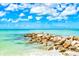 Picturesque beach view with clear turquoise water and beautiful blue sky at 800 S Blvd Of The Presidents # 3, Sarasota, FL 34236
