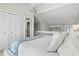 Comfortable bedroom features a king-size bed, vaulted ceiling, and convenient access to a full bathroom at 800 S Blvd Of The Presidents # 3, Sarasota, FL 34236