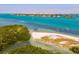 Picturesque coastal area featuring turquoise waters, a sandy beach with colorful kayaks, and lush greenery at 800 S Blvd Of The Presidents # 3, Sarasota, FL 34236