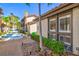 Charming exterior of a condo with a fountain, mature landscaping, and covered parking at 800 S Blvd Of The Presidents # 3, Sarasota, FL 34236