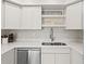 Bright, modern kitchen with white cabinets, stainless steel appliances, and a double basin sink at 800 S Blvd Of The Presidents # 3, Sarasota, FL 34236