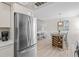 Bright kitchen area featuring stainless steel refrigerator and a dining space with modern decor at 800 S Blvd Of The Presidents # 3, Sarasota, FL 34236