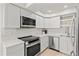 Modern kitchen featuring stainless steel appliances, ample counter space, and bright white cabinetry at 800 S Blvd Of The Presidents # 3, Sarasota, FL 34236