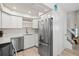 Updated kitchen with stainless steel appliances, white cabinets, and modern finishes at 800 S Blvd Of The Presidents # 3, Sarasota, FL 34236