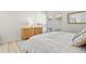 Calming main bedroom featuring white linens, bedside tables, nautical decor, and natural light at 800 S Blvd Of The Presidents # 3, Sarasota, FL 34236