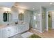 Bathroom featuring double sinks, modern fixtures, and a glass-enclosed shower with tile flooring at 805 N Bay Blvd, Anna Maria, FL 34216